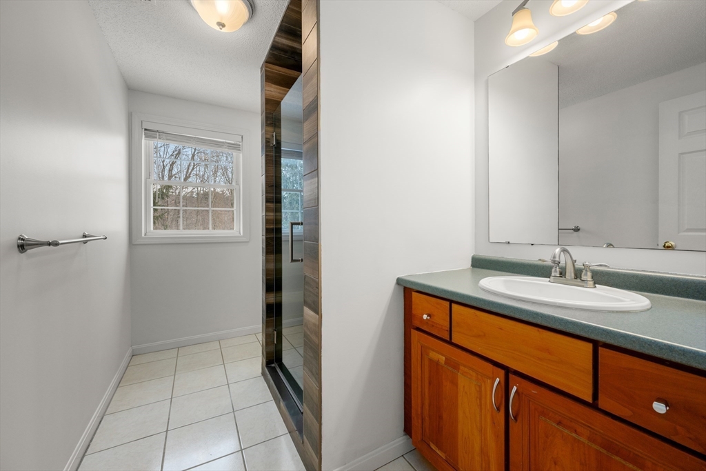 181 High Street, Unit 1 Andover, MA 01810 - Photo 15 of 21 a bathroom with a sink and a mirror