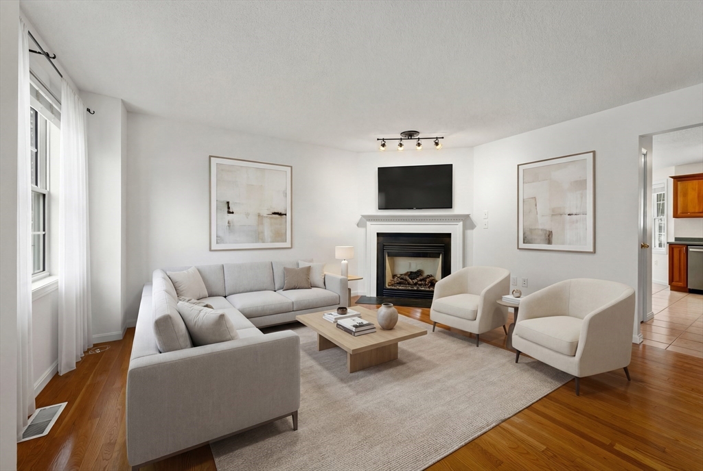 181 High Street, Unit 1 Andover, MA 01810 - Photo 2 of 21 a living room with furniture and a fireplace