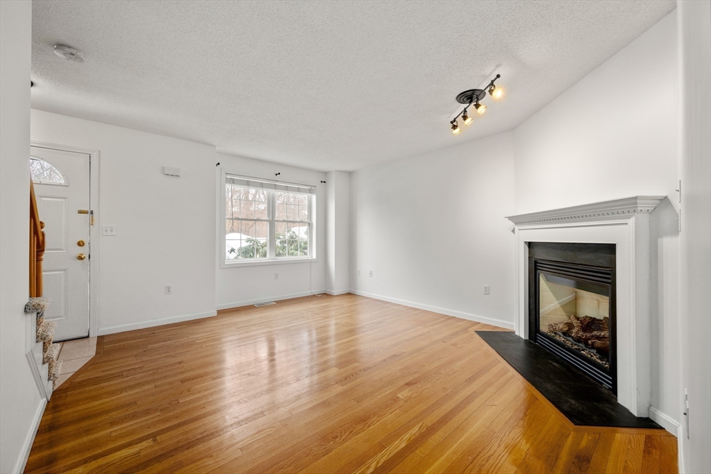 181 High Street, Unit 1 Andover, MA 01810 - Photo 4 of 21 a bedroom with a bed and a fireplace