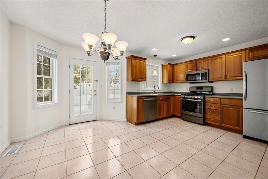 181 High Street, Unit 1 Andover, MA 01810 - Photo 8 of 21 a kitchen with stainless steel appliances granite countertop a stove a sink dishwasher a refrigerator and a refrigerator
