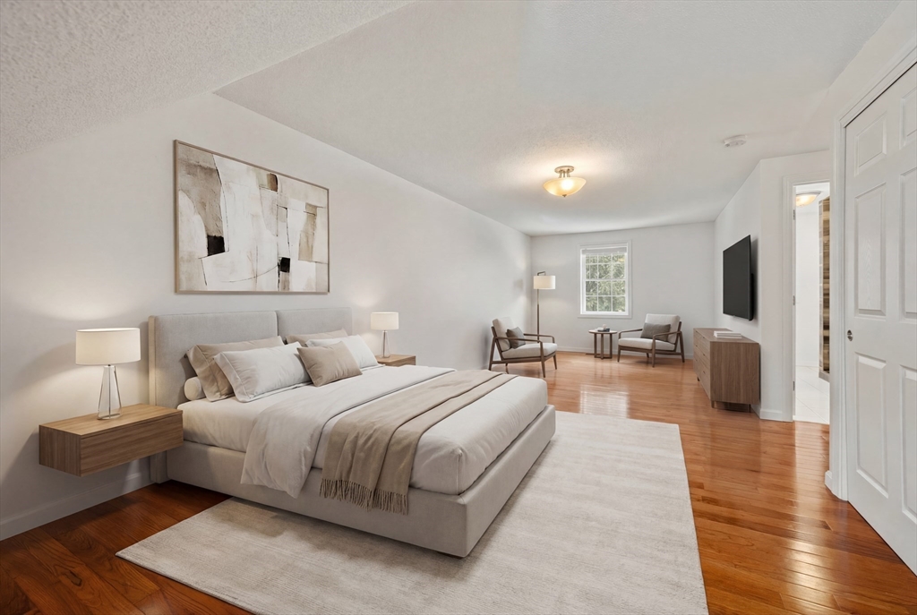 181 High Street, Unit 1 Andover, MA 01810 - Photo 10 of 21 a spacious bedroom with a bed and a view of kitchen