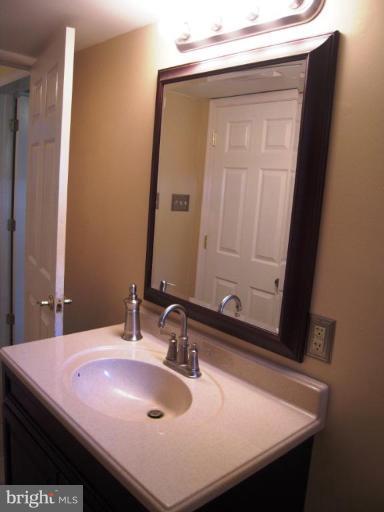 6707 Queens Ferry Road Baltimore, MD 21239 - Photo 13 of 23 a bathroom with a sink and a mirror