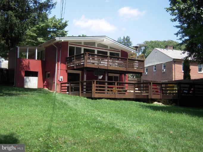 6707 Queens Ferry Road Baltimore, MD 21239 - Photo 20 of 23 a view of a house with a yard and sitting area