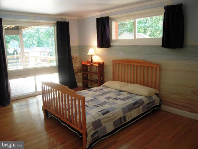 6707 Queens Ferry Road Baltimore, MD 21239 - Photo 3 of 23 a bedroom with a bed and a window