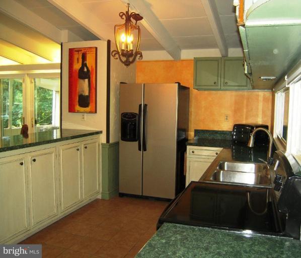 6707 Queens Ferry Road Baltimore, MD 21239 - Photo 22 of 23 a kitchen with refrigerator and window
