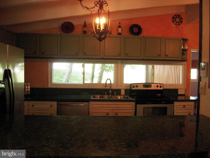 6707 Queens Ferry Road Baltimore, MD 21239 - Photo 5 of 23 a kitchen with a refrigerator and a counter