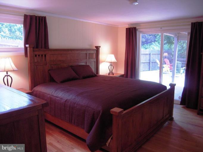 6707 Queens Ferry Road Baltimore, MD 21239 - Photo 10 of 23 a bedroom with a bed and window