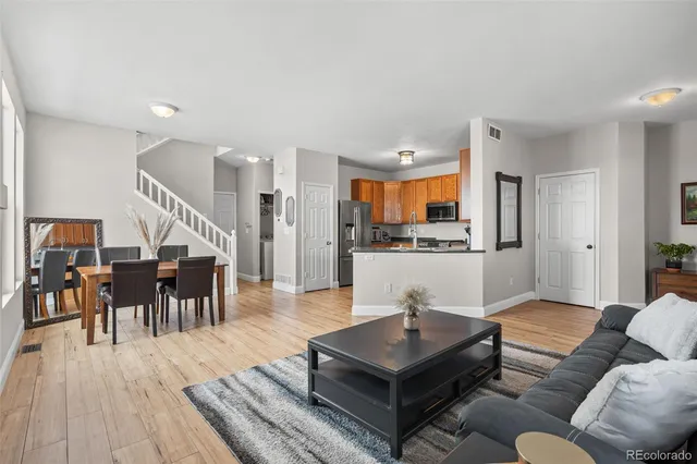 a living room with furniture and kitchen view