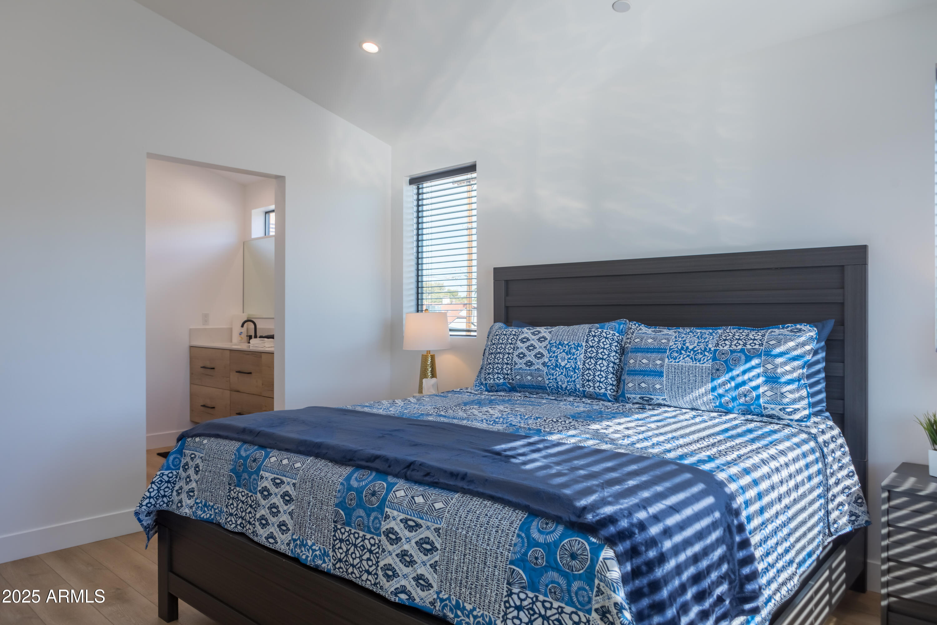 302 West Culver Street, Unit 3 Phoenix, AZ 85003 - Photo 12 of 21 a bedroom with a large bed and a tv