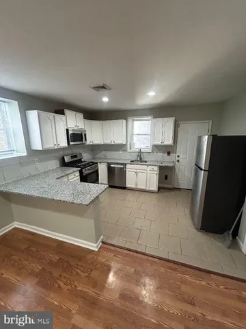 a kitchen with refrigerator and window