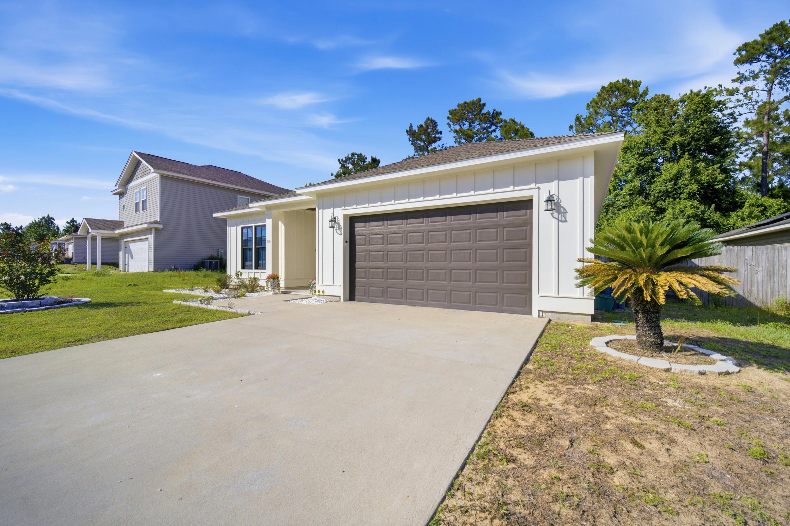 120 Lillian Way Crestview, FL 32536 - Photo 4 of 67 a view of a house with a yard and garage