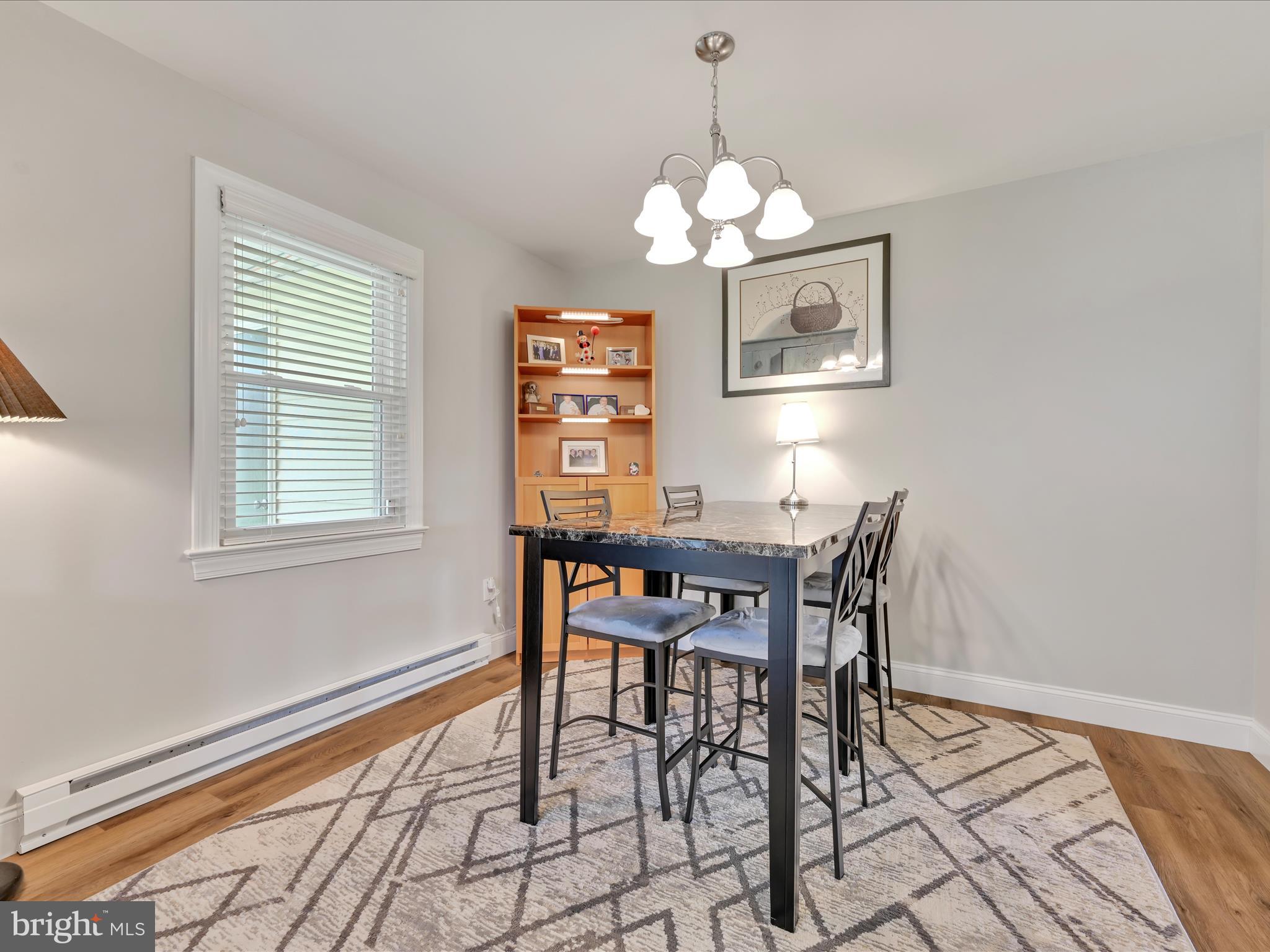 461 Crosswinds Drive Lititz, PA 17543 - Photo 13 of 32 a view of a dining room with furniture a chandelier and wooden floor