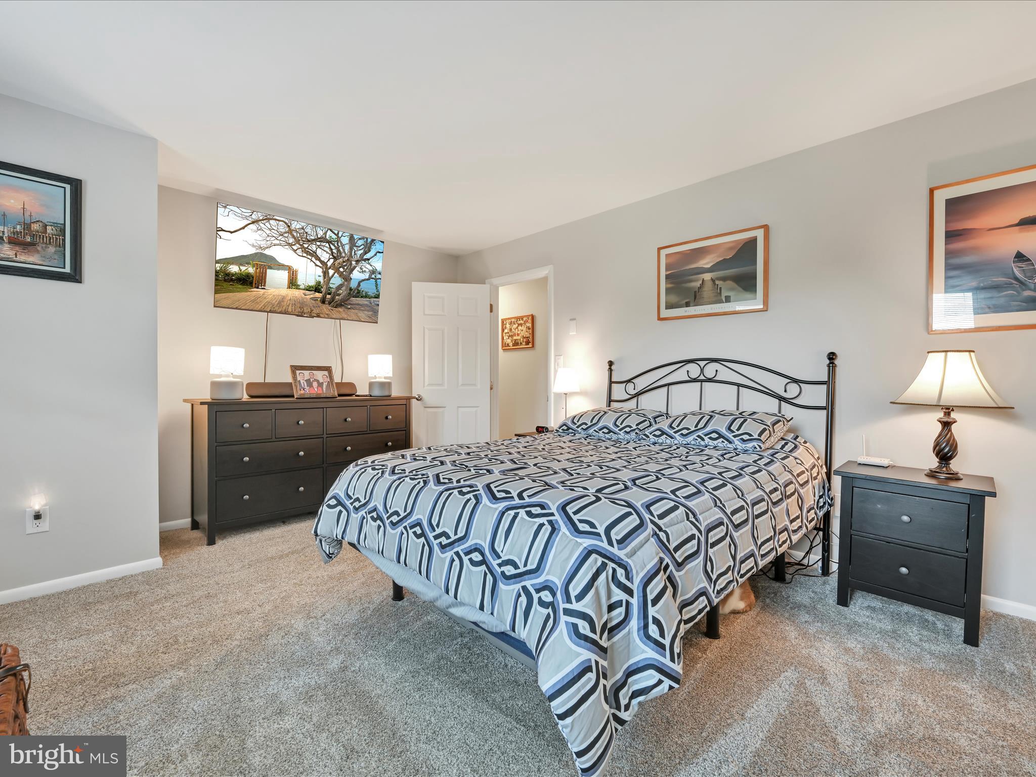 461 Crosswinds Drive Lititz, PA 17543 - Photo 19 of 32 a bedroom with a bed and a lamp on dresser