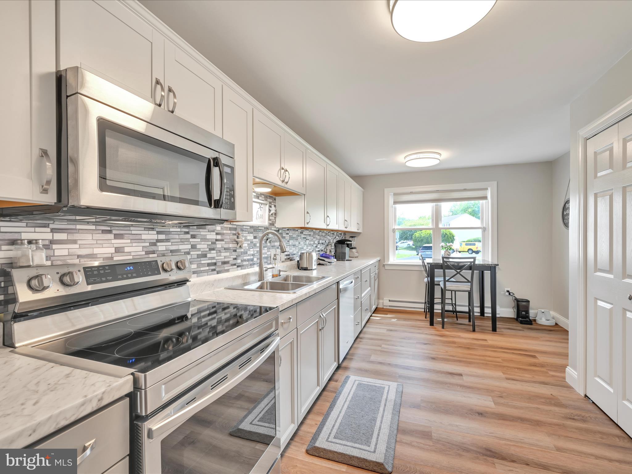 461 Crosswinds Drive Lititz, PA 17543 - Photo 6 of 32 a kitchen with stainless steel appliances stove top oven and cabinets