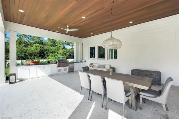 a dinning area with furniture and a large window