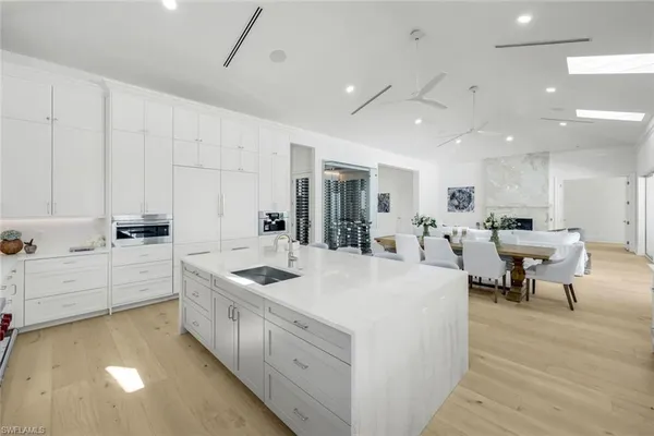 a large white kitchen with lots of counter space