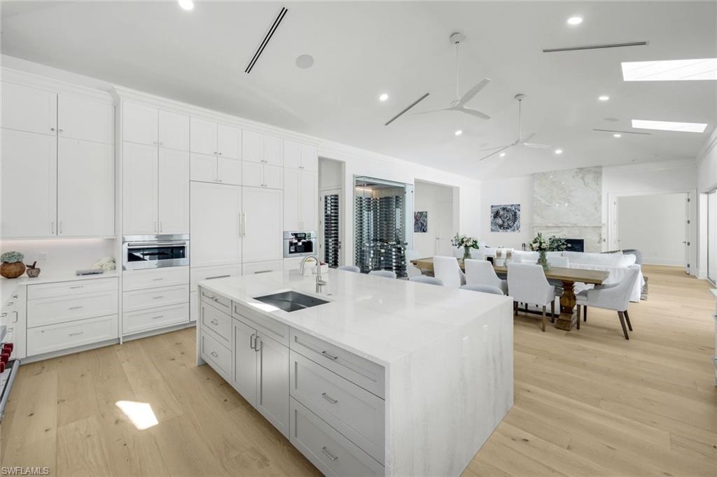 3136 Ravenna Avenue Naples, FL 34120 - Photo 19 of 50 a large white kitchen with lots of counter space