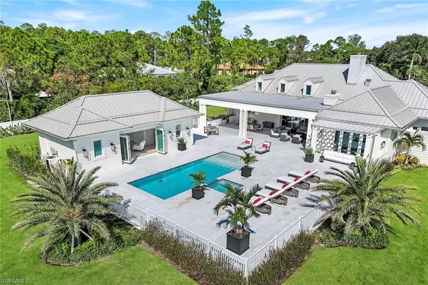 an aerial view of a house with garden space and outdoor seating