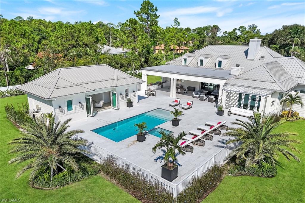 3136 Ravenna Avenue Naples, FL 34120 - Photo 2 of 50 an aerial view of a house with garden space and outdoor seating