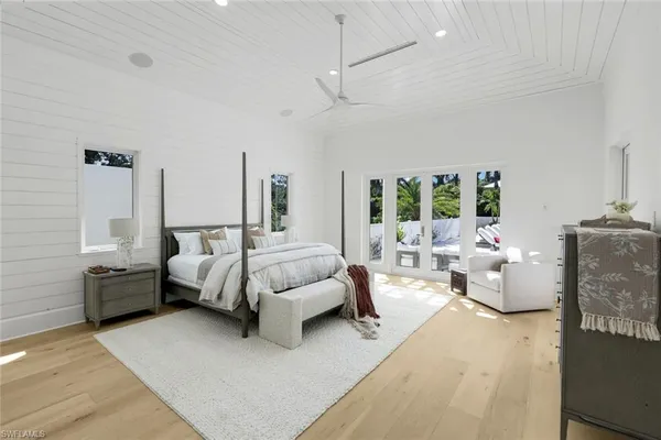 a bed room with furniture and a large window