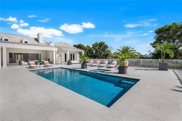a view of a swimming pool with outdoor seating