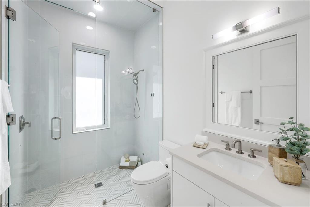 3136 Ravenna Avenue Naples, FL 34120 - Photo 34 of 50 a bathroom with a granite countertop sink toilet and shower