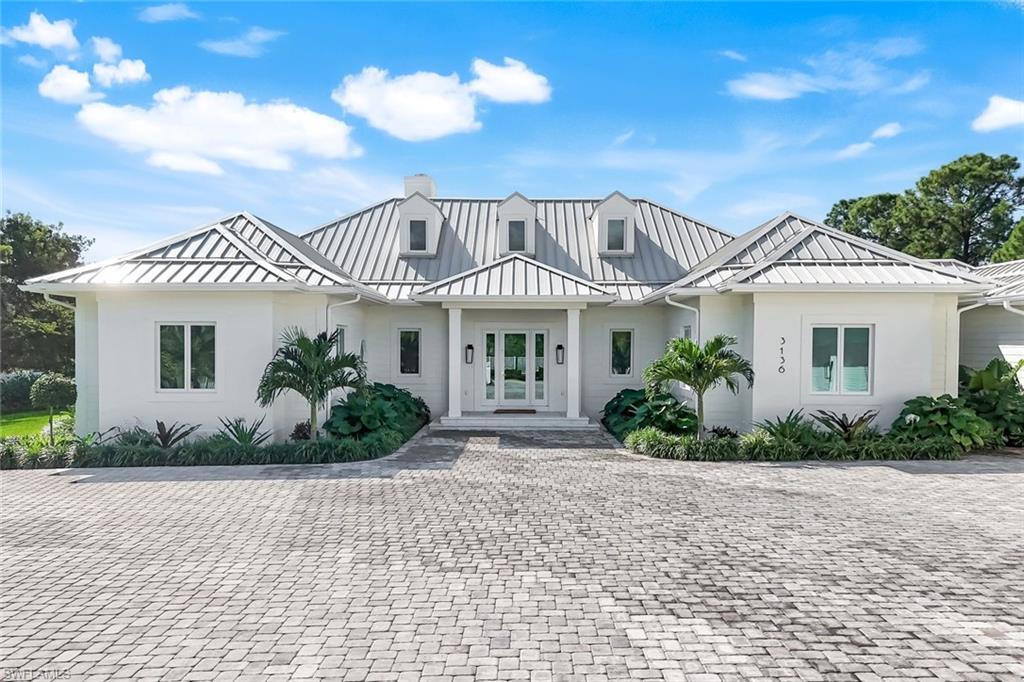3136 Ravenna Avenue Naples, FL 34120 - Photo 41 of 50 a front view of a house with a yard