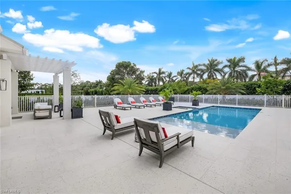 a view of swimming pool with outdoor seating and plants