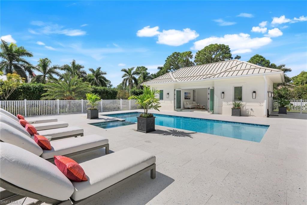 3136 Ravenna Avenue Naples, FL 34120 - Photo 10 of 50 a view of a patio with couches and table and chairs with wooden fence