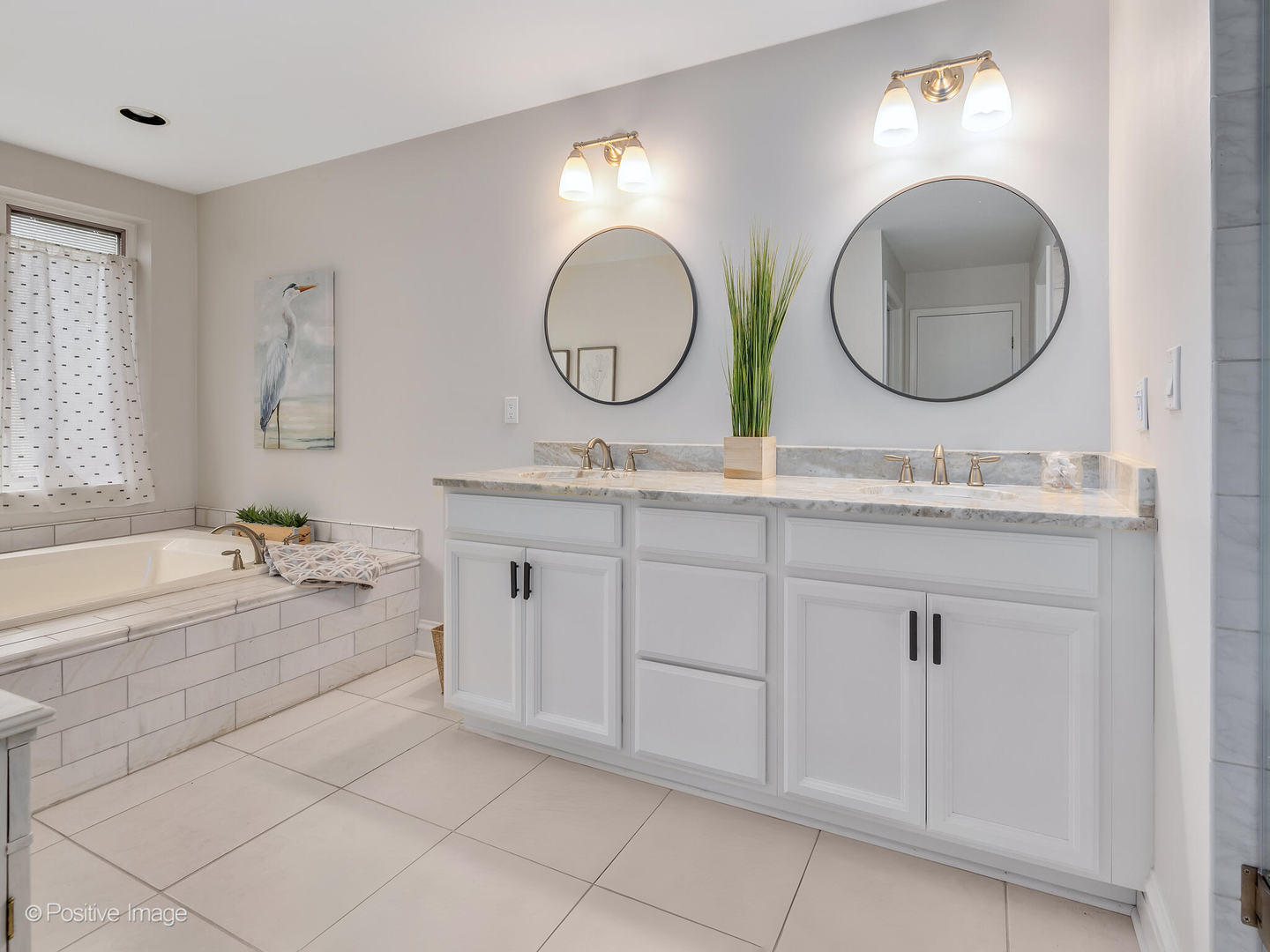 11 Manchester Lane Elmhurst, IL 60126 - Photo 14 of 29 a bathroom with a double vanity sink and a mirror