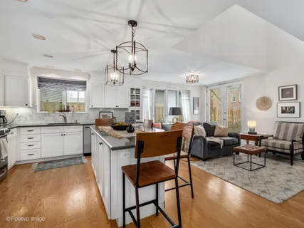 a living room with furniture kitchen view and a table
