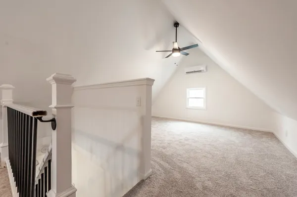 an empty room with windows and closet