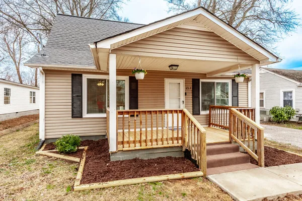 a view of a house with wooden floor and a yard