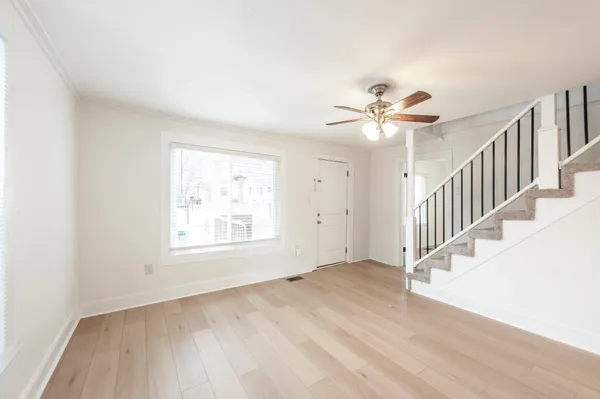 wooden floor in an empty room with a window
