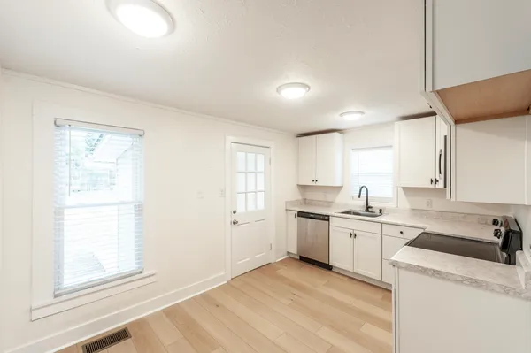 a kitchen with a sink stove and cabinets