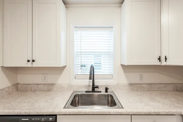 a kitchen with a sink and cabinets