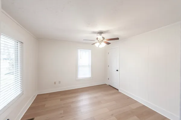 wooden floor in an empty room with a window