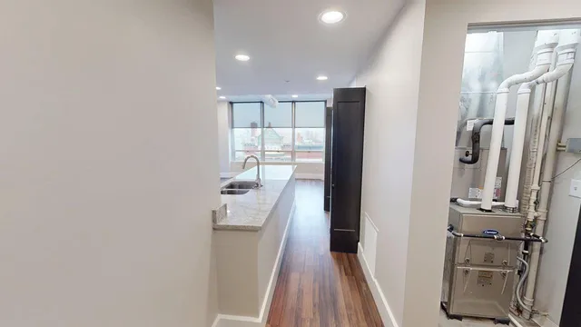 a kitchen with stainless steel appliances kitchen island granite countertop a refrigerator and a stove top oven