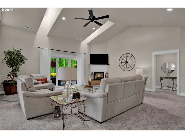 a living room with fireplace furniture and a potted plant