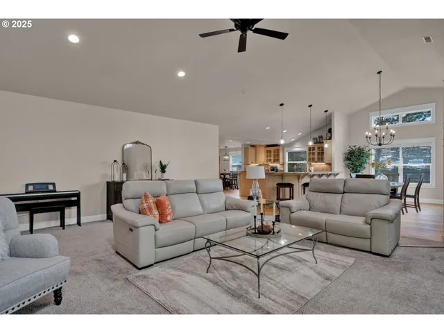 a living room with furniture and a ceiling fan
