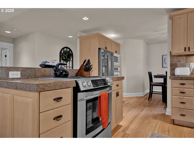 a kitchen with a stove a sink and a refrigerator