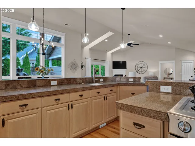 a kitchen with a sink and a clock