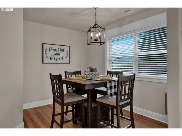 a view of a dining room with furniture and chandelier