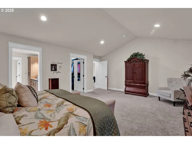 a spacious bedroom with a bed and a couch