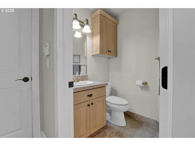 a bathroom with a sink a toilet a shower and a mirror