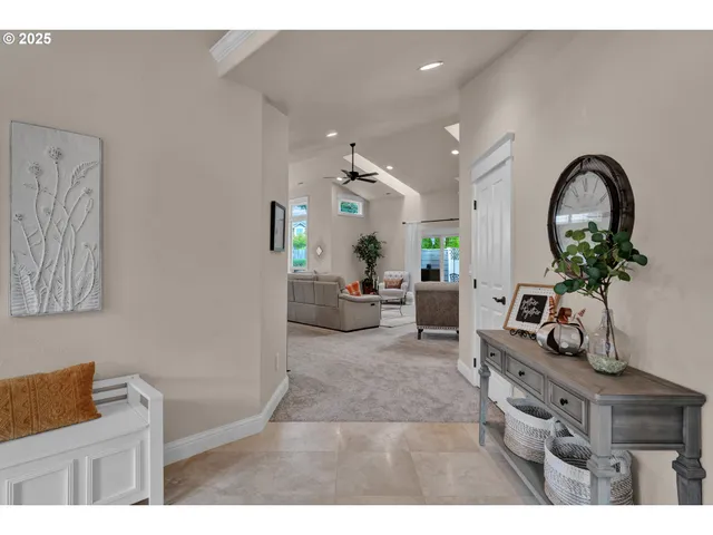 a living room with furniture a potted plant and a chandelier