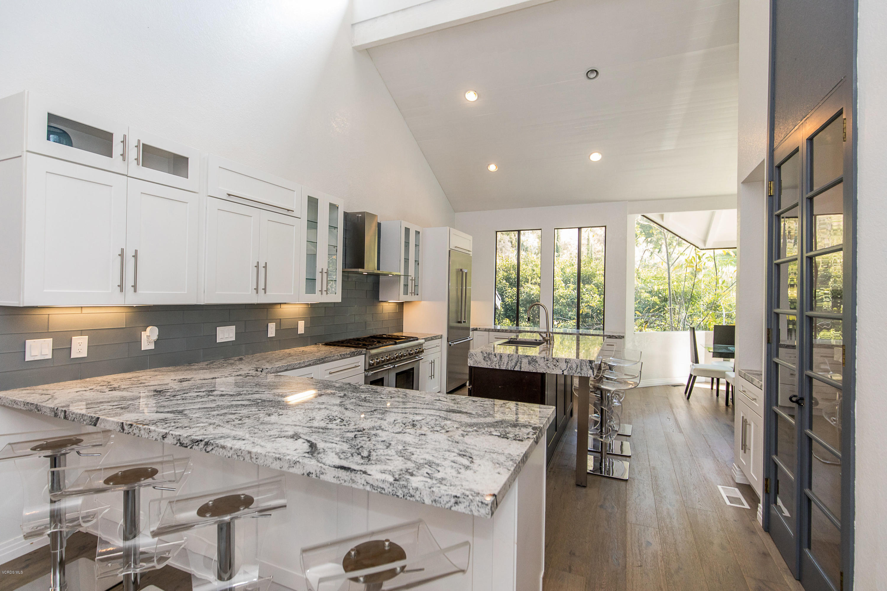2001 Roscomare Road Los Angeles, CA 90077 - Photo 12 of 52 a kitchen with stainless steel appliances granite countertop sink stove refrigerator and wooden floor