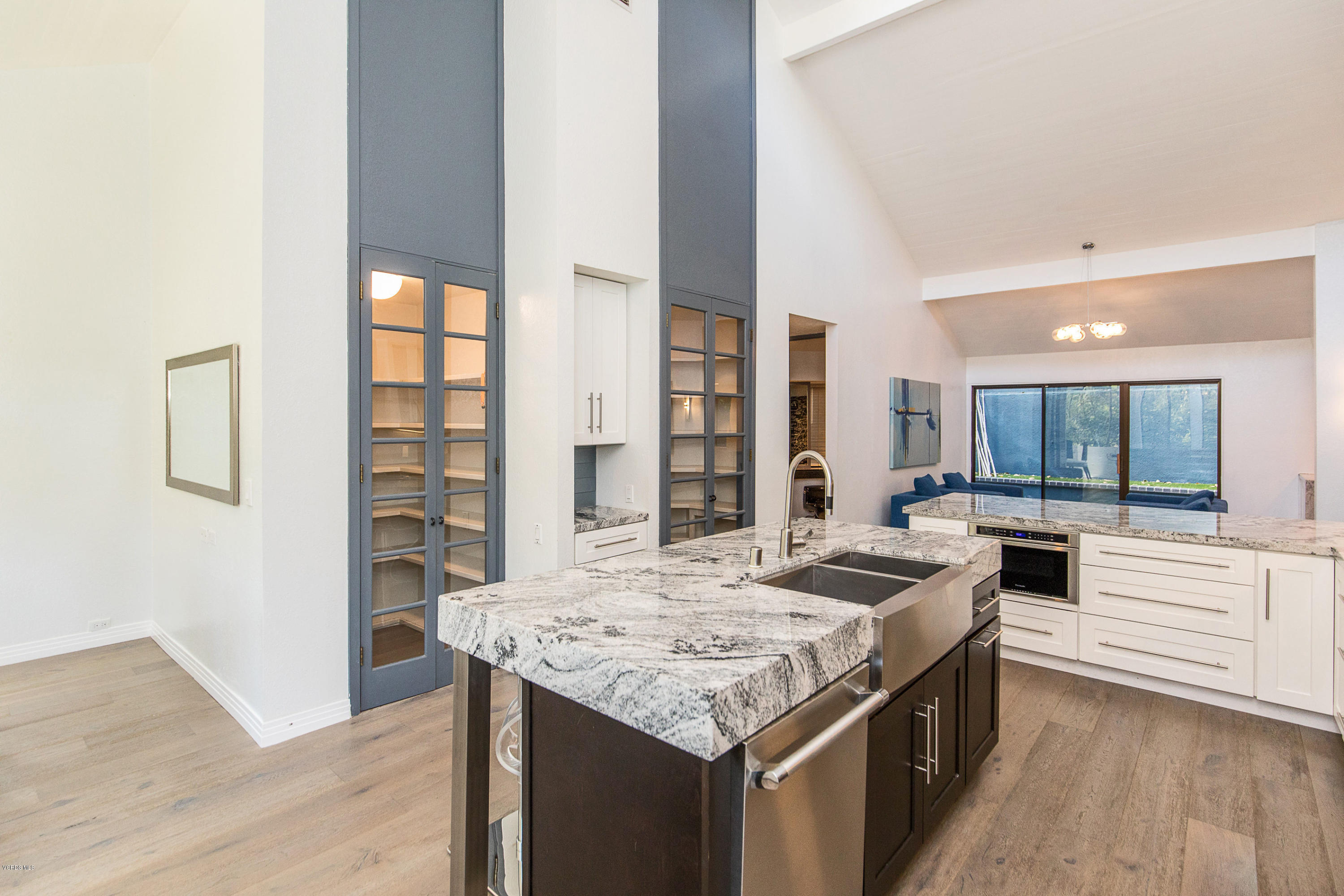 2001 Roscomare Road Los Angeles, CA 90077 - Photo 15 of 52 a kitchen with granite countertop a stove and a refrigerator
