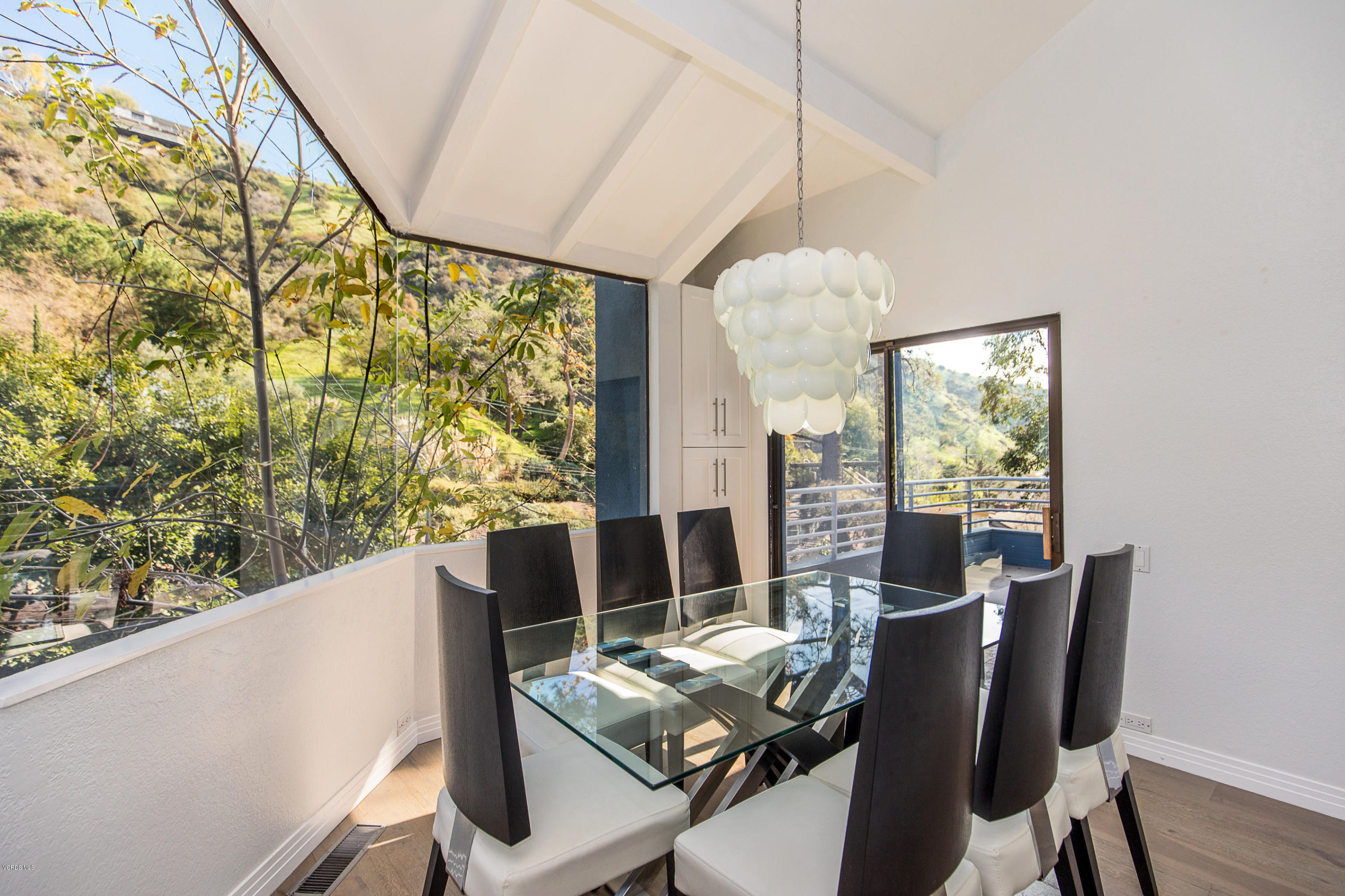 2001 Roscomare Road Los Angeles, CA 90077 - Photo 16 of 52 a view of a dining room with furniture window and outside view