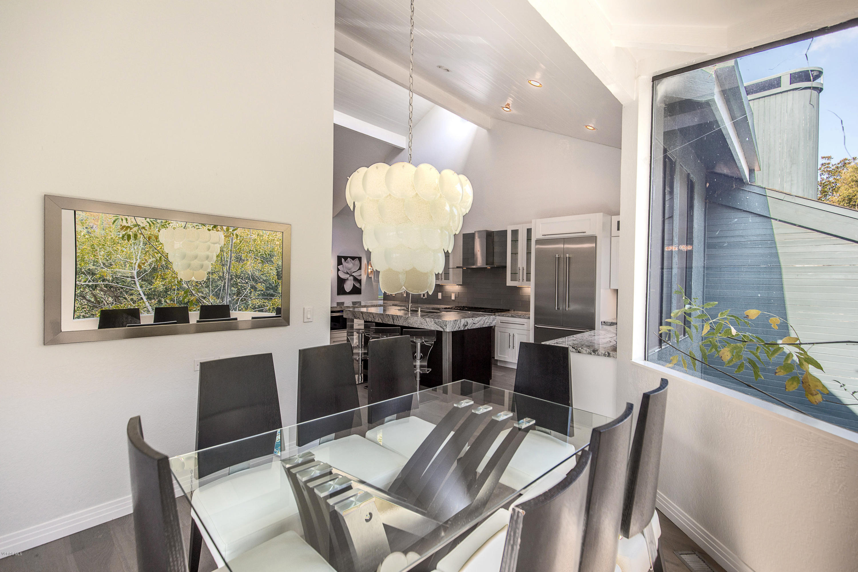 2001 Roscomare Road Los Angeles, CA 90077 - Photo 17 of 52 a view of a dining room with furniture a chandelier and wooden floor